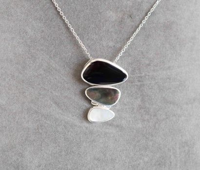 null Solid silver pendant set with a cut onyx enhanced with two iridescent white...