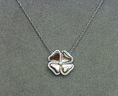 A white gold pendant forming a flower made...