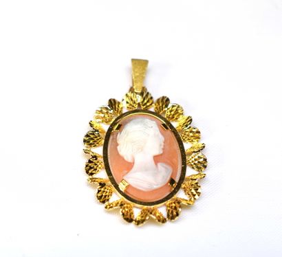 A yellow gold pendant with a stylized frame...