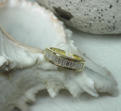 Yellow gold rail wedding ring set with baguette...