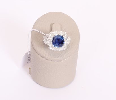  White gold ring centered with a NATURAL UNHEATED cushion sapphire, probably Ceylon,...