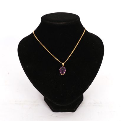 GOLD PENDANT WITH A VIOLET STONE

Marked...