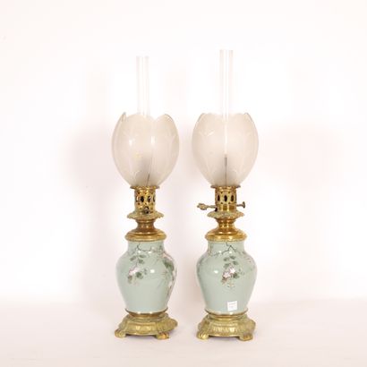  PAIR OF OIL LAMPS WITH BRANCHES ON A CELADON BACKGROUND 
Brass and glassware, globes...