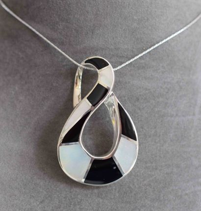 null Solid silver pendant on its chain modern form, tendril of onyx and white mother-of-pearl...