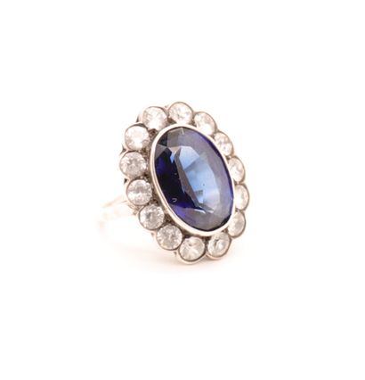 RING WITH A BIG BLUE STONE 

Surrounded by...