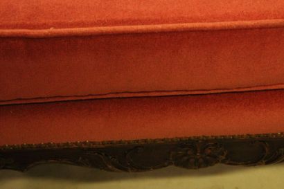 null Walnut bench resting on eight curved feet, red fabric upholstery consisting...