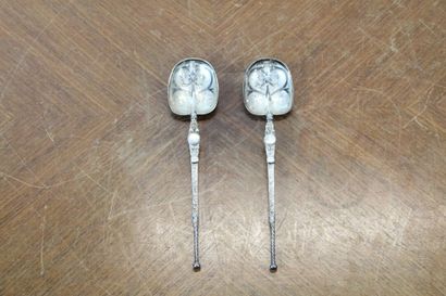 Two serving spoons in chased silver with...