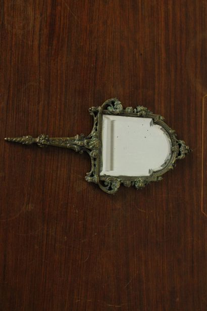 null Hand mirror in chased bronze decorated with scrolls and stylized flowers. 19th...