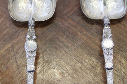 null Two serving spoons in chased silver with stylized flowers and interlacing. European...