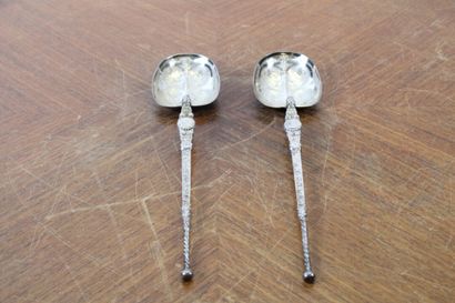 null Two serving spoons in chased silver with stylized flowers and interlacing. European...