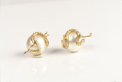 null Sleeper earrings made of South Sea cultured pearls, decorated with a small diamond-paved...
