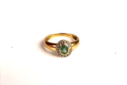 null 18K (750/1000) yellow gold band ring centered on a close-set oval emerald in...