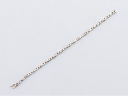 null 18 karat (750 thousandths) white gold river bracelet set with a line of brilliant-cut...