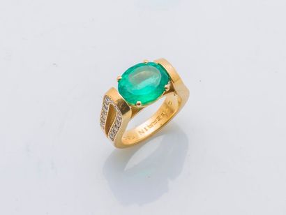 OJ PERRIN 18 karat (750 thousandths) yellow gold ring set with an oval emerald of...