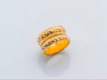 null A 14 carat (585 thousandths) yellow gold ring made of three rings with chased...
