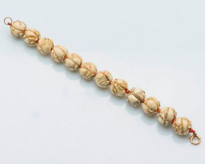 null Bracelet adorned with twelve ojime in marine ivory carved with mice alternating...
