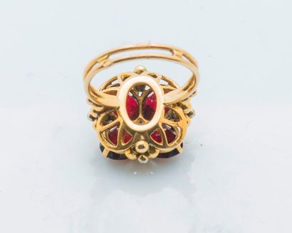 null 18 karat yellow gold clover ring (750 thousandths) set with four red stones...