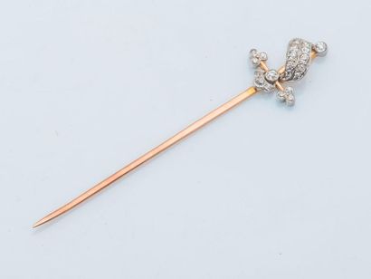 null A 9-carat (375 thousandths) yellow gold pin stylizing a sword, the hilt enhanced...