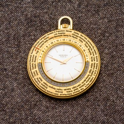 HERMES Paris Montre de poche "World Time" en métal doré à lunettes tournantes avec...