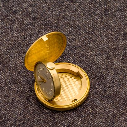 MOVADO 18 karat (750 thousandths) yellow gold pocket watch in the shape of a coin...
