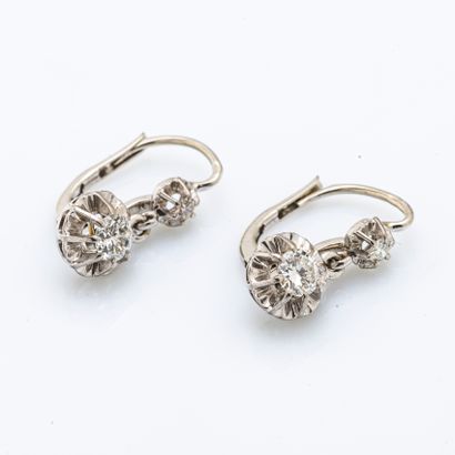 null Pair of 18 karat white gold sleepers (750 thousandths) each holding two diamonds.

H:...