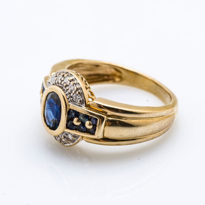 null 18 karat (750 thousandths) yellow gold ring set with an oval sapphire surrounded...