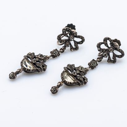 null Pair of silver ear clips (800 thousandths) stylizing a ribboned bow holding...