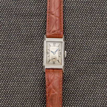 null LONGINES, circa 1940 

Rectangular steel bracelet watch with cut-off sides....