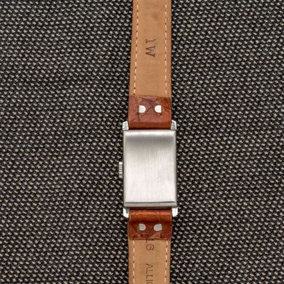 null LONGINES, circa 1940 

Rectangular steel bracelet watch with cut-off sides....