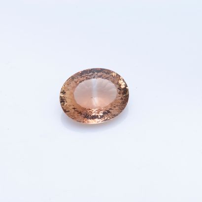 null Oval-sized brown topaz on paper.

Weight: 28.91 carats