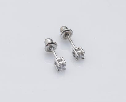 null 
A pair of 18K (750 ‰) white gold earrings each set with a diamond weighing...