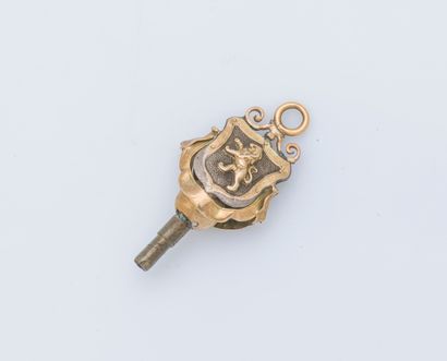 null Metal watch key surmounted by a coat of arms featuring a standing lion. 19th...