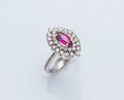 null An 18K (750 ‰) white gold marquise ring set with a red navette stone within...