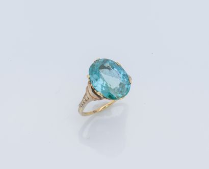 null A 14-karat (585 ‰) yellow and white gold ring set with an oval-cut blue zircon,...