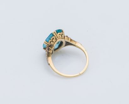 null A 14-karat (585 ‰) yellow and white gold ring set with an oval-cut blue zircon,...
