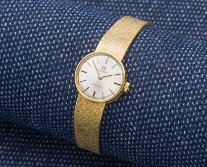 OMEGA Ladies' watch bracelet in 18K yellow gold (750 ‰), the round case with clipped...