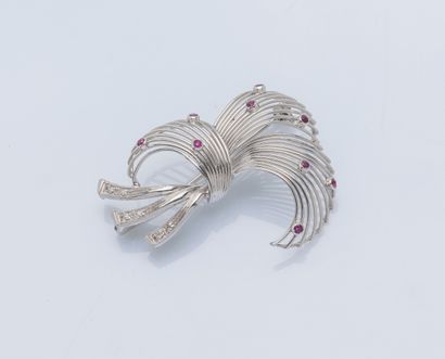 null 18K (750 ‰) white gold brooch styling a spray set with nine small rubies and...