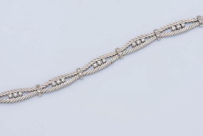 null Bracelet in 18K white gold (750 ‰) composed of two lines of chased gold punctuated...