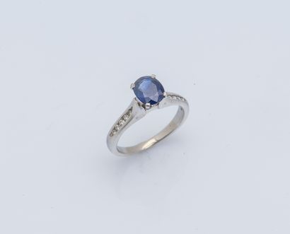 null 
Platinum ring (950 ‰) adorned with an oval-cut sapphire, shouldered with rail-set...