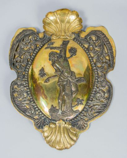 null Gilded brass plate with chased metal decoration of a martyr, scrolls and shells

43...