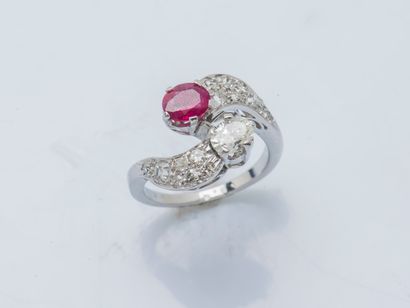 null An 18K (750 ‰) white gold toi et moi ring set with an oval diamond and ruby,...