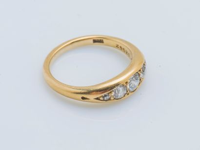  An 18K (750 ‰) yellow gold garter ring set with a line of five brilliant-cut diamonds,...