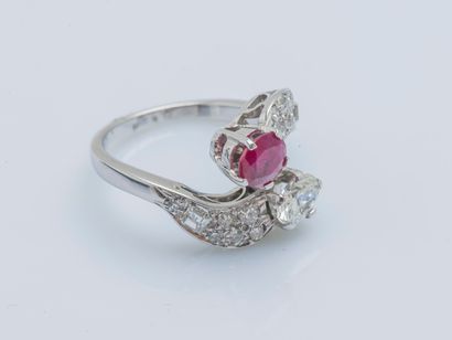 null An 18K (750 ‰) white gold toi et moi ring set with an oval diamond and ruby,...