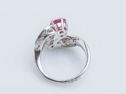  An 18K (750 ‰) white gold toi et moi ring set with an oval diamond and ruby, each...
