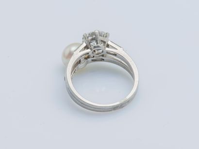  A platinum (950 ‰) toi et moi ring set with a half-cut diamond weighing approximately...