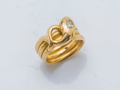  An 18k yellow gold (750 ‰) snake ring, the head set with an old-cut diamond weighing...