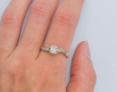  An 18K (750 ‰) yellow gold ring set with a cushion diamond calibrating 0.45 carat...