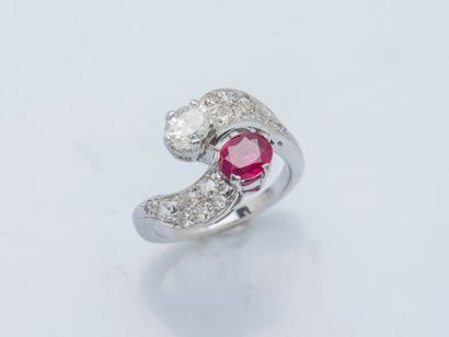  An 18K (750 ‰) white gold toi et moi ring set with an oval diamond and ruby, each...