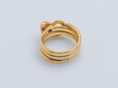  An 18k yellow gold (750 ‰) snake ring, the head set with an old-cut diamond weighing...