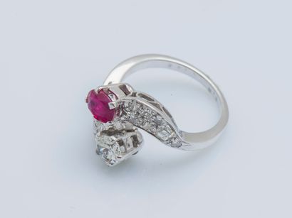 null An 18K (750 ‰) white gold toi et moi ring set with an oval diamond and ruby,...